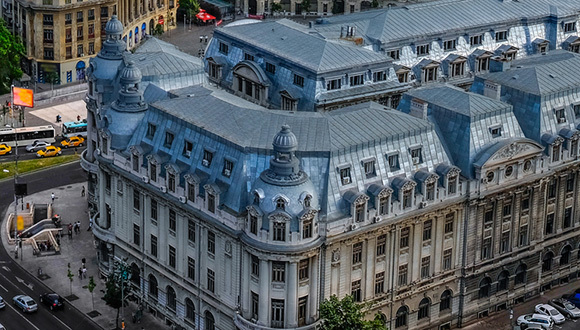 A photo of Bucharest city center. Traffic surrounds a 